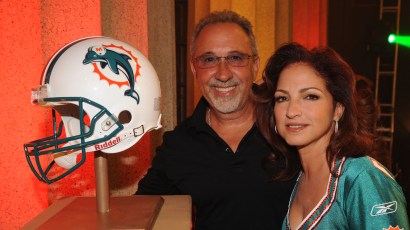 NASHVILLE, TN - JUNE 22: Emilio Estefan and Gloria Estefan pose with their team The Miami Dolphins helmet before joining Hank Williams Jr. to sing "Are You Ready for some Football" in Spanish as part NASHVILLE, TN - JUNE 22: Emilio Estefan and Gloria Estefan pose with their team The Miami Dolphins helmet before joining Hank Williams Jr. to sing "Are You Ready for some Football" in Spanish as part