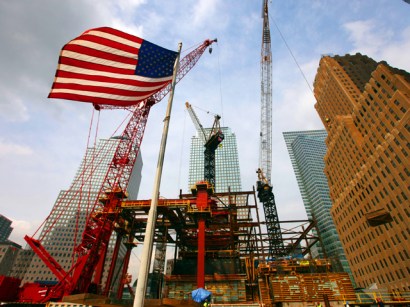 American flag flies in front of the construction site at the former World Trade Center site. Eight years after the 9/11 attacks, the rebuilding drags along slowly.