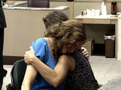 Christine Kent hugs a friend during the sentencing of a man who paralyzed her.