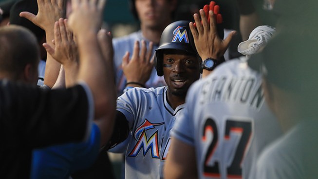 Conley strikes out seven, lifts Marlins past Reds, 7-3