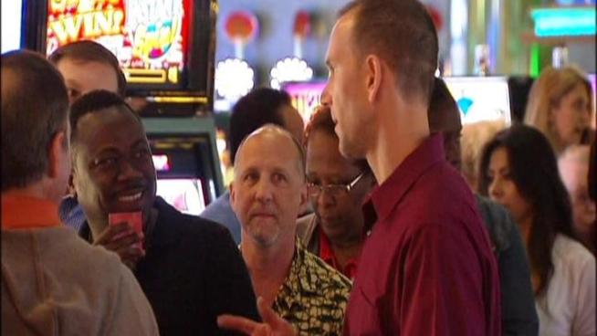 Customers like Adrian Robinson weigh in at Gulf Stream Park Casino in Hallandale Beach for a Fat Tuesday promotion. Gulfstream's director of Marketing, Michael Goldin, explains the promotion to reporter Adam Kuperstein.