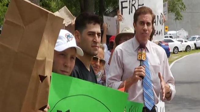 Frustrated and fed up, about three dozen Miami Dolphins fans protested the team's free agent failures just across the street from its Davie training facility Tuesday. 