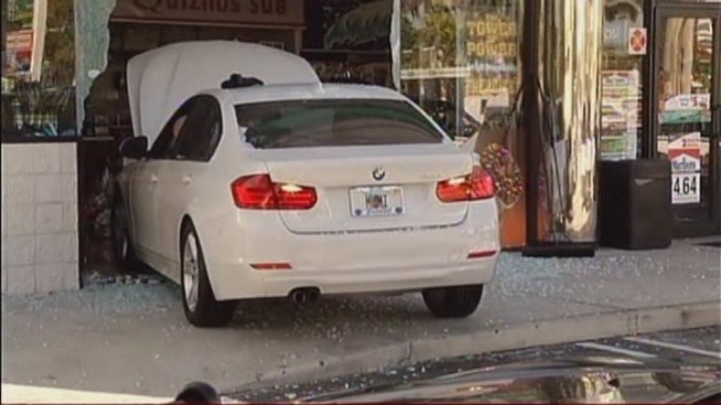 The woman, who didn't want to be identified, said she was stopping for donuts on her way to work when she somehow drove her 2012 BMW into the front of the Hess station.