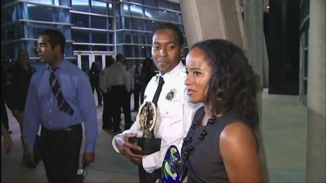 A Miami-Dade firefighter and his fiancee were honored Tuesday night for saving the life of an Aventura police officer who was attacked by a man last month. Regianne Georges and fiancee Michelle Thompson accepted awards at a ceremony for their heroic actions in helping Aventura Police Lt. Michael Bentolila.