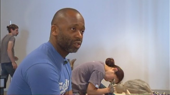 At Theaster Gates' exhibit at Locust Projects in Miami there are no paintings on the walls, not much color either. But there is art and its messy, physical process, Gates said