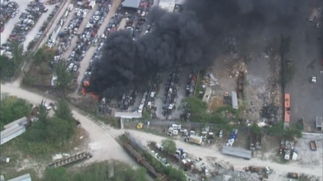 Firefighters battle a blaze at a junkyard in Opa-locka.