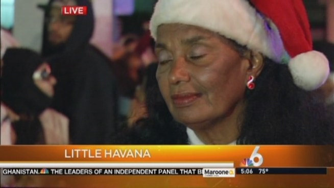 Residents line up to receive free meal baskets in Little Havana. Juanita Alvarez discusses the giveaway.