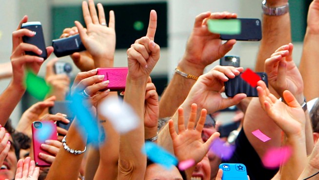 Excited fans cheer for the Miami Heat Monday as Burnie and several cars pass by. The Miami Heat defeated the Oklahoma City Thunder Thursday to win the NBA finals.