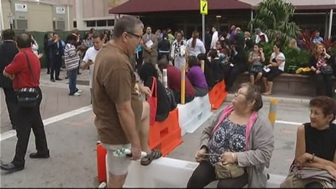 Employees and customers of the Broward County Courthouse react to the gas leak Wednesday morning.
