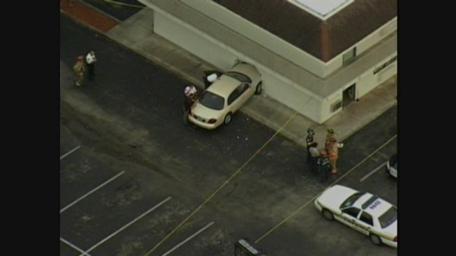 Authorities respond after a car crashes into a wall at a Dania Beach motel.
