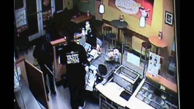 Surveillance video of an armed robbery at a Sunrise Quiznos Sub.