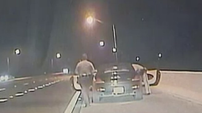 A Titusville doctor who intentionally hurt himself while in custody in the back of a patrol car is facing a battery charge after he spit blood onto a trooper s face, the Florida Highway Patrol reported.