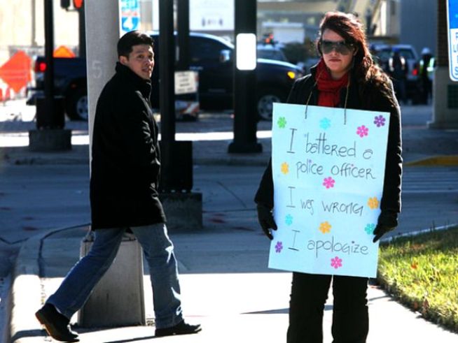 Woman Sentenced to Hold "Police-Beater" Sign