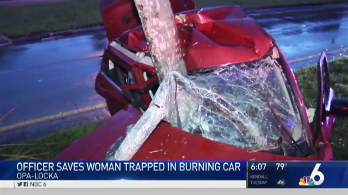 Officer Saves Woman Trapped in Burning Car