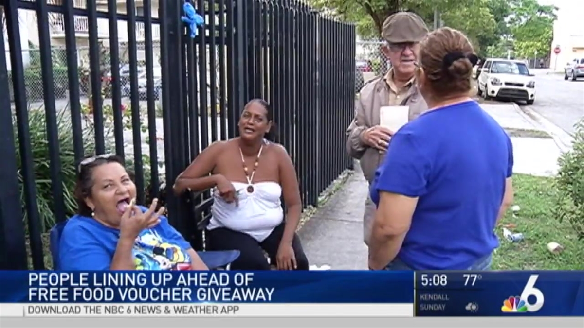 People Line Up Ahead of Free Food Voucher Giveaway