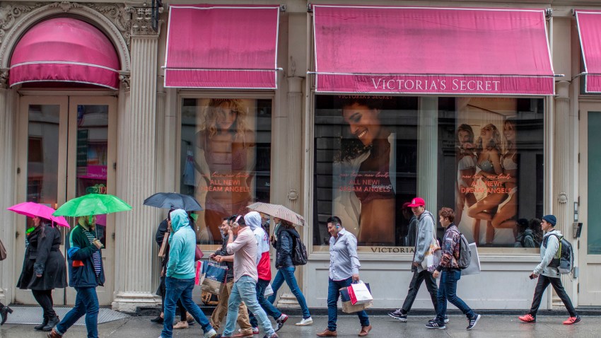 FILE- In this April 4, 2018, file photo, shoppers walk past the Victoria's Secret store on Broadway in the Soho neighborhood of New York.