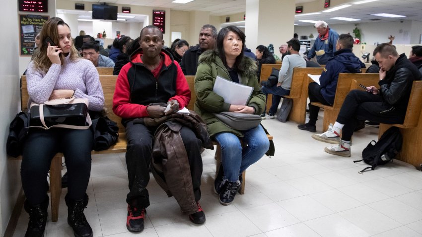 People wait to be served in a Department of Motor Vehicles office, Monday, Dec. 16, 2019 in New York. Undocumented immigrants in the state will be able to apply for driver’s licenses Monday after the state’s so-called “Green Light Law” went into effect. License applicants without a valid Social Security number will be able to submit alternative forms of ID that include valid passports and driver’s licenses issued in other countries. Applicants must still get a permit and pass a road test to qualify for a “standard driver’s license.” (AP Photo/Mark Lennihan)