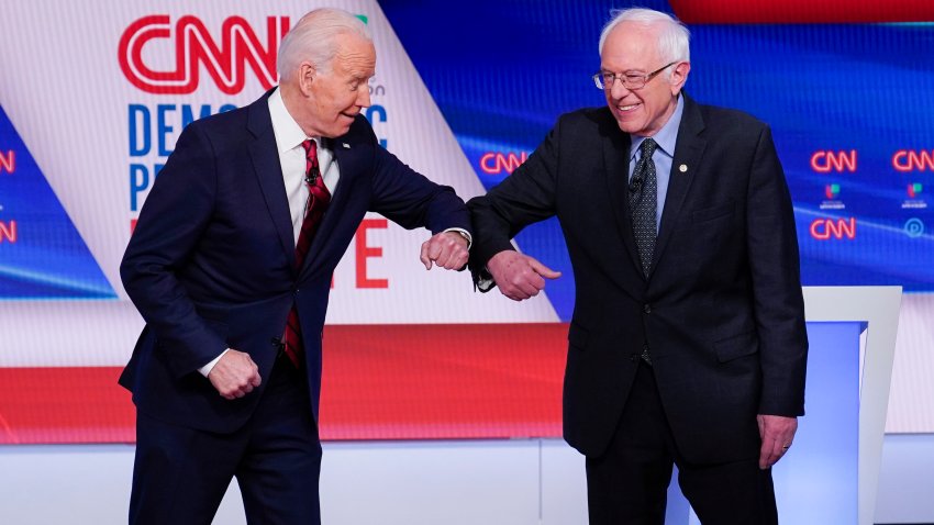 Former Vice President Joe Biden, left, and Sen. Bernie Sanders, I-Vt., right, greet one another before they participate in a Democratic presidential primary debate at CNN Studios in Washington, Sunday, March 15, 2020.