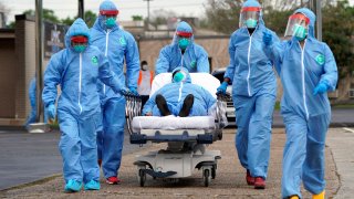 Medical professionals transport a patient