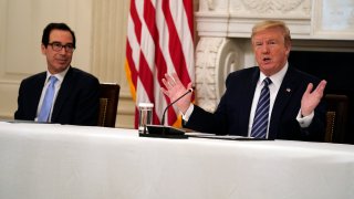 President Donald Trump speaks during a meeting with Republican lawmakers, in the State Dining Room of the White House, Friday, May 8, 2020, in Washington. Treasury Secretary Steven Mnuchin listens at left.