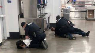 In this March 23, 2020 frame grab taken from video, Marvia Gray, left and her son Derek Gray are arrested at a Sam's Club store in Des Peres, Missouri. A lawsuit filed Monday May 18, 2020, accuses four white suburban St. Louis police officers of brutalizing Gray and her adult son after wrongly accusing them of stealing a television. Gray alleges she suffered serious and permanent injuries during her arrest. Her 43-year-old son, Derek, suffered a concussion, three shattered teeth and other injuries, according to the lawsuit.