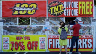 People purchase fireworks on Thursday, July 2, 2020, in Dublin, Calif. For many Americans, the Fourth of July won't be about big festivities but setting off fireworks themselves. Hundreds of cities and towns have canceled shows Saturday because of the coronavirus pandemic, and sales of consumer fireworks are booming; though officials are concerned about fires and injuries with more pyrotechnics going off in backyards and at block parties.