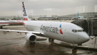 In this Jan. 29, 2013, file photo, a new American Airlines 737-800 aircraft featuring a new paint job with the company’s new logo sits at a gate at O'Hare Airport in Chicago, Illinois.