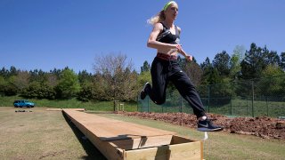 Olympic pole vaulting silver medalist Sandi Morris runs on the vaulting pit she is building with her father in Greenville, S.C., April 14, 2020.