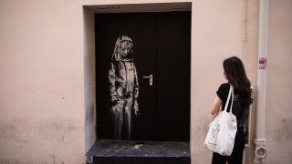 In this June 26, 2018, file photo, Banksy's art is seen on a side street next to the Bataclan concert hall where a terrorist attack killed 90 people in 2015, in Paris, France.