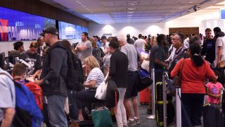 Passengers arrive at Orlando International Airport for departing flights ahead of the arrival of Hurricane Dorian on August 30, 2019.