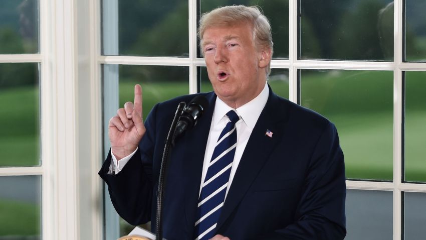 President Donald Trump gestures as he speaks during a dinner with business leaders in Bedminster, New Jersey, on Aug. 7, 2018.