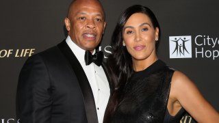 Rapper / Music Producer Dr. Dre (L) and his Wife Nicole Young (R) attend the City Of Hope Gala on October 11, 2018 in Los Angeles, California.