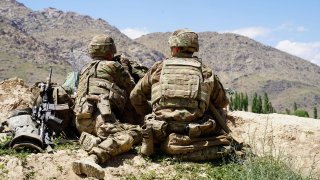 In this photo taken on June 6, 2019, U.S. soldiers look out over hillsides in the Nerkh district of Wardak province, Afghanistan.
