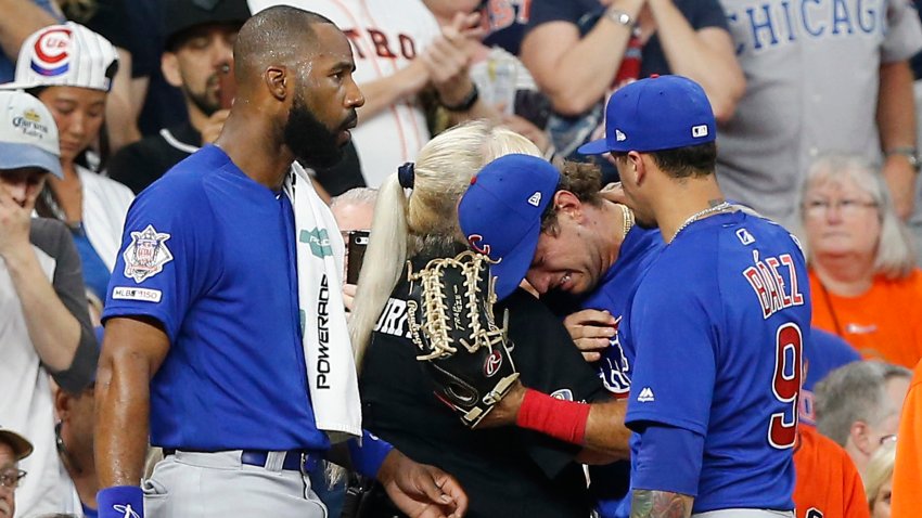 Albert Almora Jr. #5 of the Chicago Cubs, center, is comforted by Jason Heyward #22 and Javier Baez #9 after checking on a young child that was struck by a hard foul ball off his bat in the fourth inning against the Houston Astros at Minute Maid Park on May 29, 2019 in Houston, Texas.