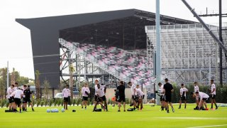 Players stretch on the field as the new stadium is being built in the distance during Inter Miami’s first practice at their new training site, former Lockhart Stadium, in Fort Lauderdale, Fla. on Monday, Feb. 10, 2020. (Daniel A. Varela/Miami Herald/Tribune News Service via Getty Images)