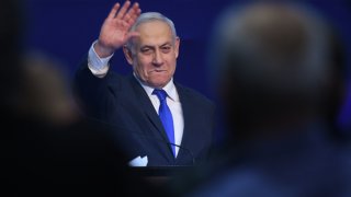 In this Tuesday, March 3, 2020, photo, Israeli Prime Minister Benjamin Netanyahu gestures as he speaks to supporters following the announcement of exit polls in Israel's election at his Likud party headquarters in Tel Aviv.