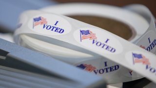 In this April 7, 2020, file photo, I voted stickers sit on a table during a presidential primary election at the Journey Church in Kenosha, Wisconsin.