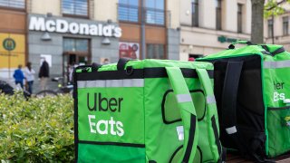 Uber Eats delivery bags wait in front of a McDonald's in Lublin, Poland on May 3, 2020.