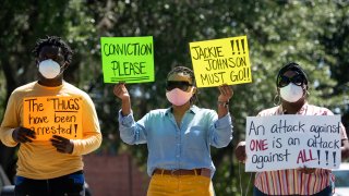 In this May 8, 2020, file photo, demonstrators protest the shooting death of Ahmaud Arbery at the Glynn County Courthouse in Brunswick, Georgia. Gregory McMichael and Travis McMichael were arrested the previous night and charged with murder.