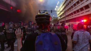 A protester holds up his hands