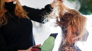 Hair stylist blow drying hair