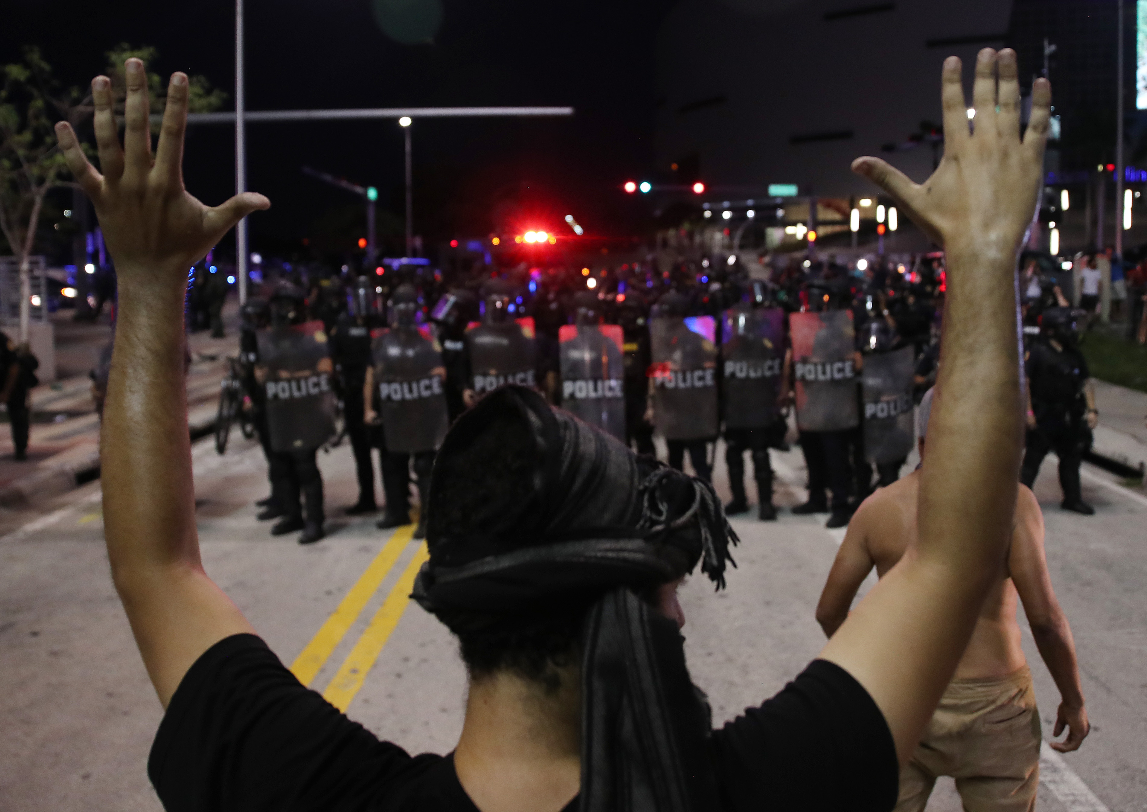 Police watch as demonstrators block a roadway while protesting against police brutality and the death of George Floyd, on May 31, 2020 in Miami, Florida.