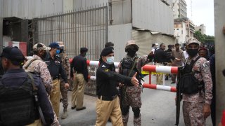 Security personnel gather at the main entrance of the Pakistan Stock Exchange building in Karachi on June 29, 2020.