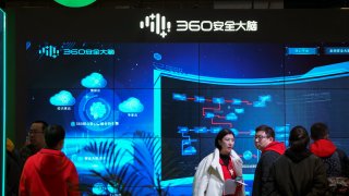 In this Nov. 21, 2019, file photo, visitors tour the Chinese internet security firm Qihoo 360 showcasing its 5G digital security and protection system at the World 5G Convention in Beijing. One of China's biggest tech companies has criticized the Trump administration for "politicizing business" after it slapped export sanctions on 33 more Chinese enterprises and government entities.