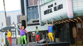 Universal Studio cast members perform during the first day of reopening from the coronavirus pandemic at Universal Orlando Resort, June 5, 2020, in Orlando, Fla.