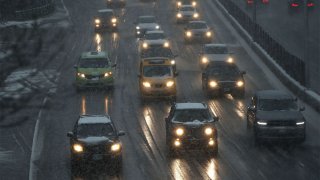 In this March 7, 2018, file photo, cars drive through wet snow along a highway in the Brooklyn borough of New York.
