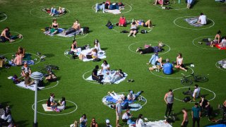 People practice social distancing in Domino Park in Williamsburg during the coronavirus pandemic on May 17, 2020 in New York City.