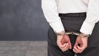crime-stock-white-collar-handcuffs-professional-businessman