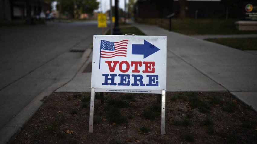 In this Aug. 14, 2018, file photo, a sign reading "Vote Here" points toward a polling place for the 2018 Minnesota primary election at Holy Trinity Lutheran Church in Minneapolis, Minnesota.