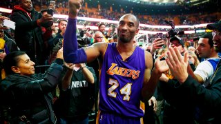 Los Angeles Lakers' Kobe Bryant acknowledges the crowd as he leaves the court after their 112-104 win over the Boston Celtics in his final regular season NBA basketball game in Boston, Dec. 30, 2015.